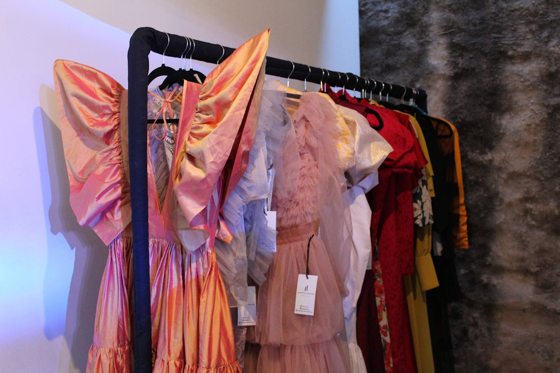 pink and beige dress hanged on black plastic clothes hanger