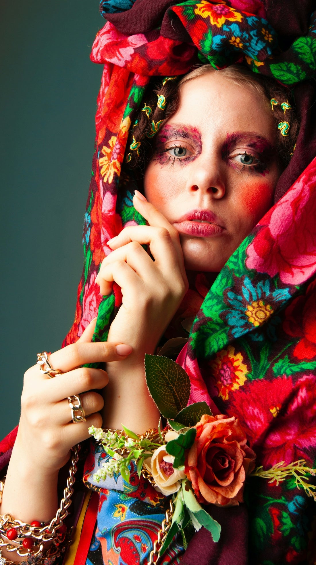 a woman with a flower headdress holding her hand up