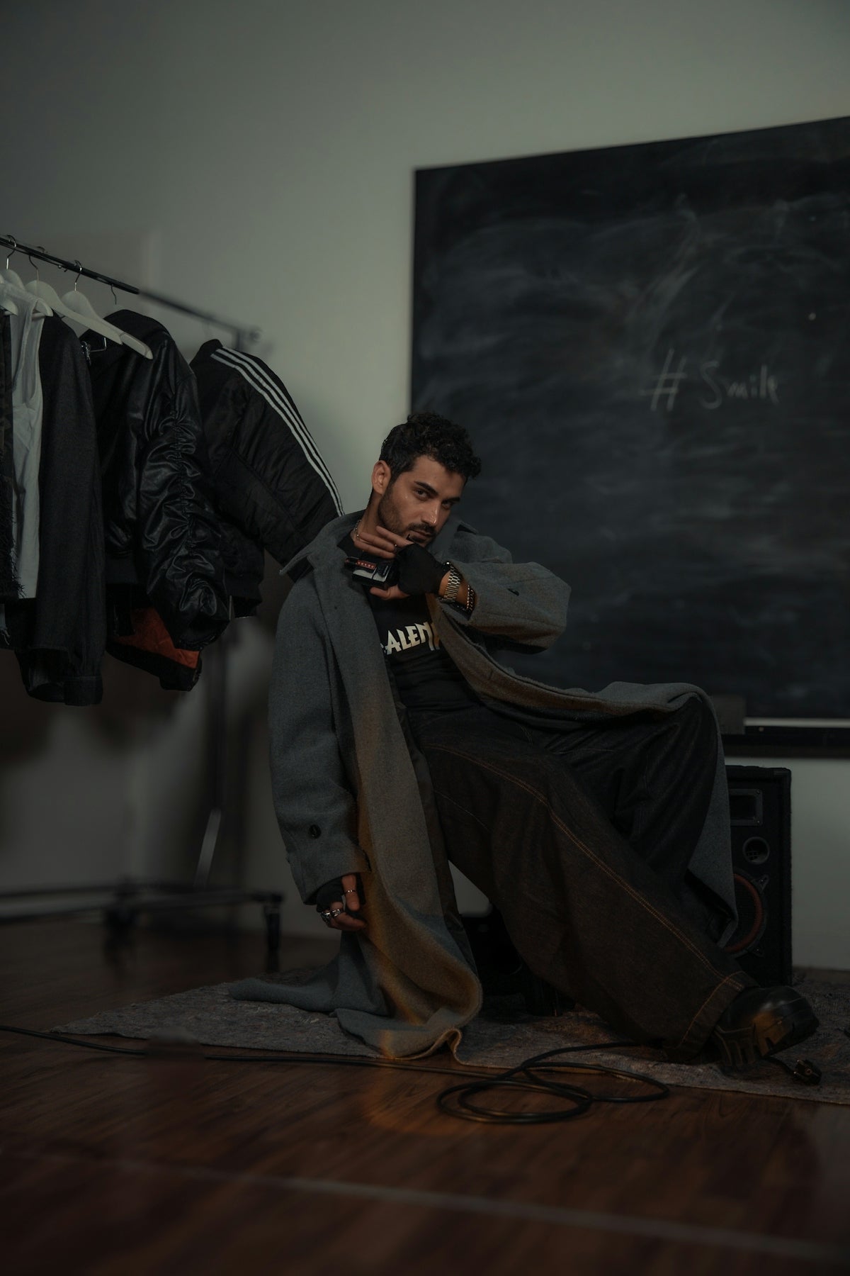 A man poses in a fashion-forward outfit.