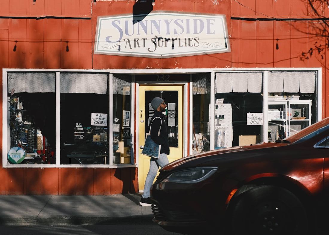 A person walks past sunnyside art supplies.