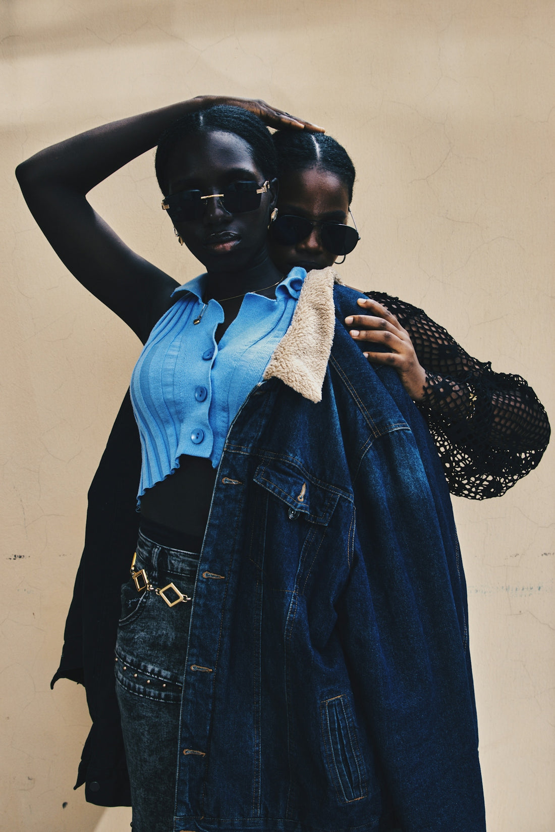 Two women wearing sunglasses and stylish outfits