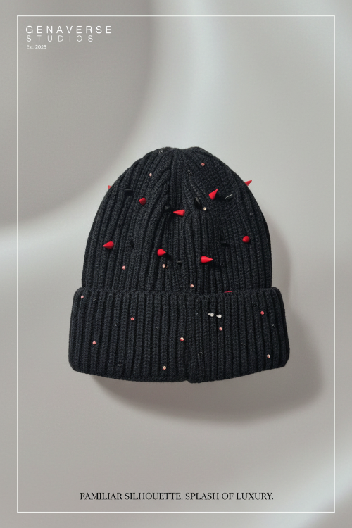 Black knit beanie with red embellishments on a light gray background